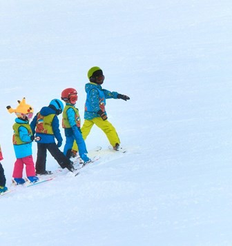 A group of kids skiing.