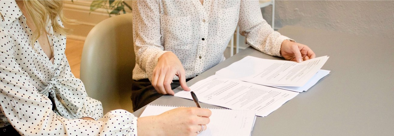 A person signing a document.