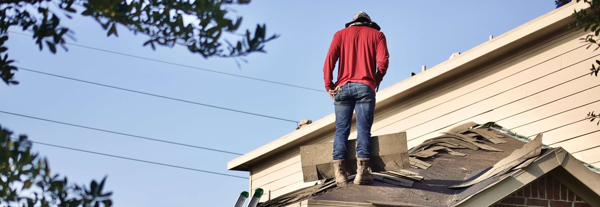 A person standing on a roof.